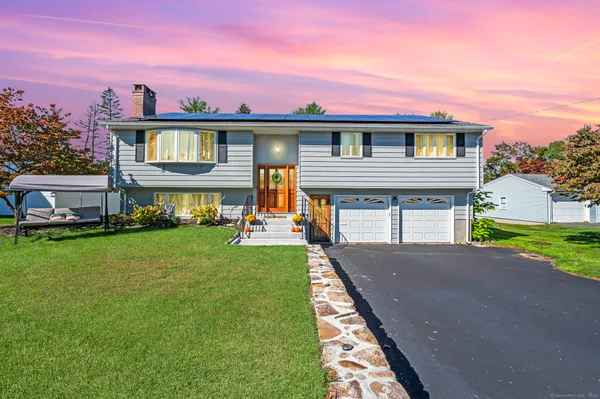 a front view of a house with a yard table and chairs