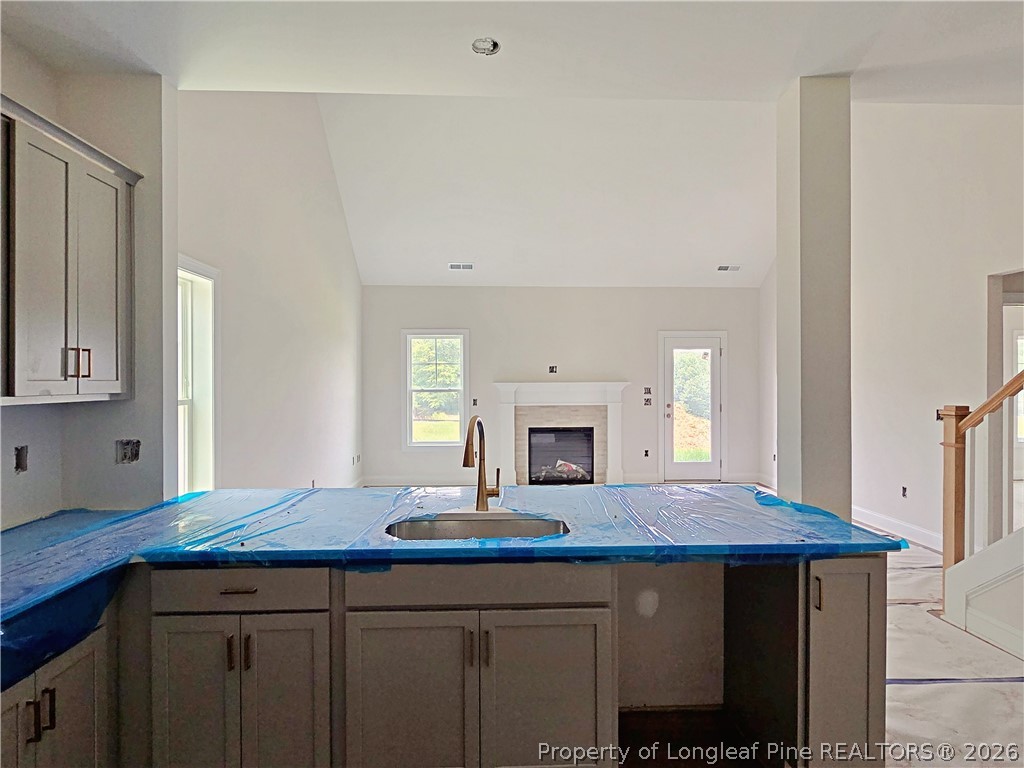 2678 Norrington Road Lillington, NC 27546 - Photo 9 of 31 a view of kitchen island sink refrigerator and microwave