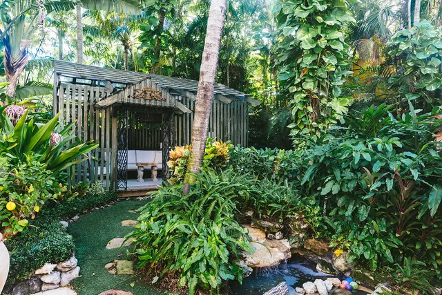 a view of a patio with table and chairs potted plants