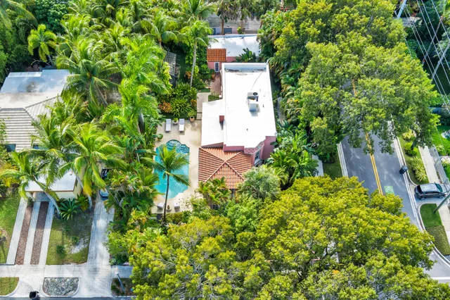 an aerial view of residential house with outdoor space and trees all around