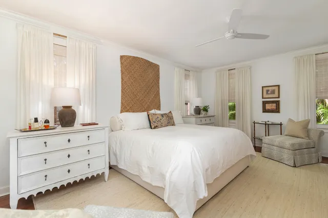 a spacious bedroom with a bed and a dresser