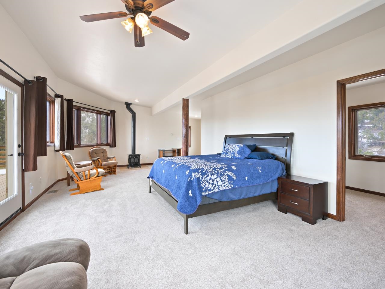 18461 Little Park Road Glade Park, CO 81523 - Photo 20 of 42 a bedroom with a bed couch and a window