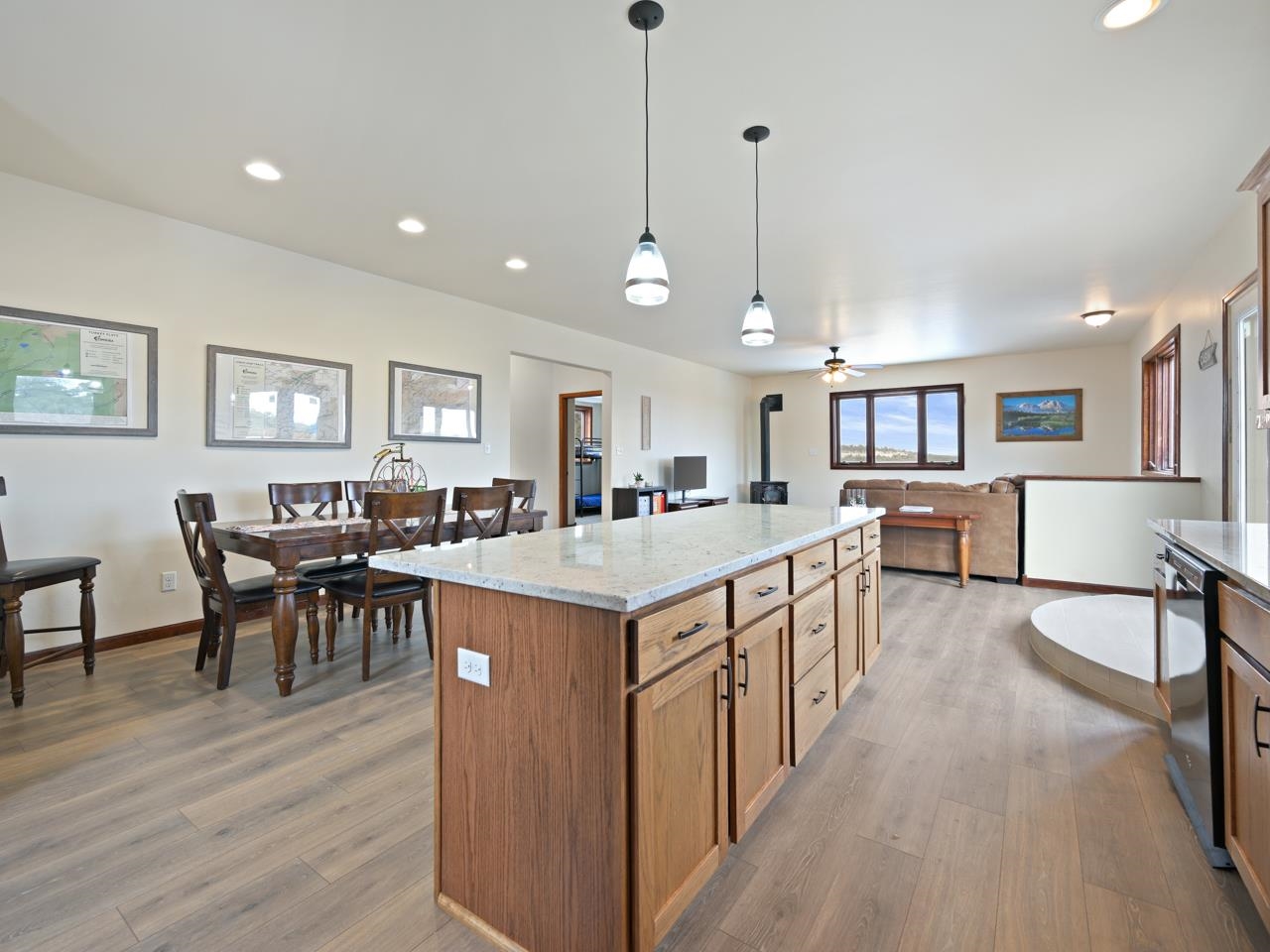 18461 Little Park Road Glade Park, CO 81523 - Photo 4 of 42 a open kitchen with stainless steel appliances granite countertop a stove center island a dining table and chairs with wooden floor