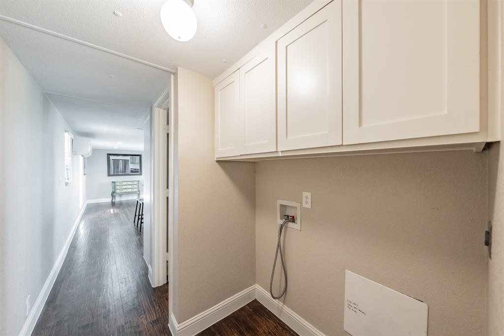 1080 Crow Lane Terrell, TX 75161 - Photo 11 of 39 Laundry room with dark wood-style floors, hookup for a washing machine, Dryer, and cabinet space