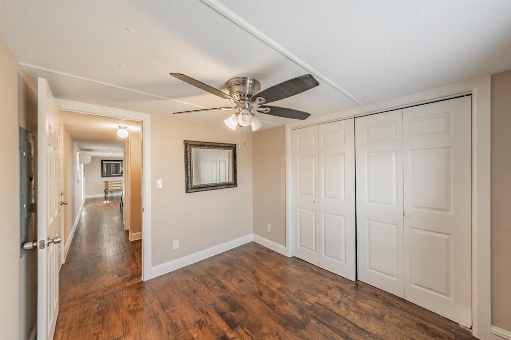 1080 Crow Lane Terrell, TX 75161 - Photo 14 of 39 Primary bedroom with dark wood-style floors, a closet, and a ceiling fan