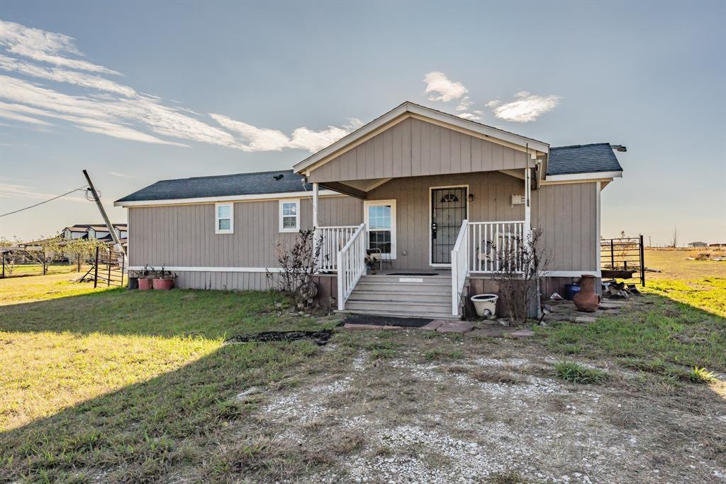 1080 Crow Lane Terrell, TX 75161 - Photo 2 of 39 Manufactured / mobile home featuring a porch, a front yard, and a shingled roof