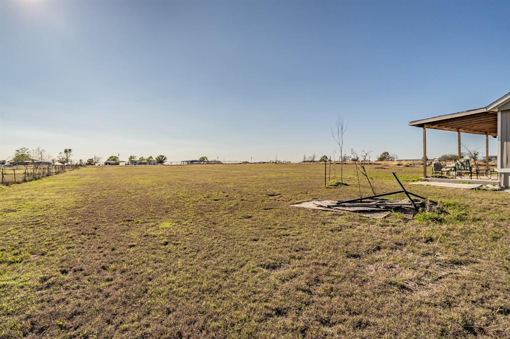 1080 Crow Lane Terrell, TX 75161 - Photo 26 of 39 View of grassy yard with a view of rural / pastoral area and a patio