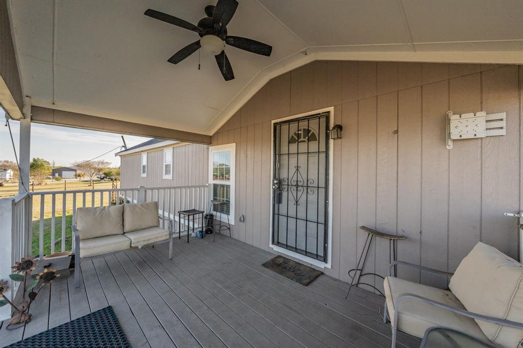 1080 Crow Lane Terrell, TX 75161 - Photo 4 of 39 Wooden deck with a ceiling fan and an outdoor living space