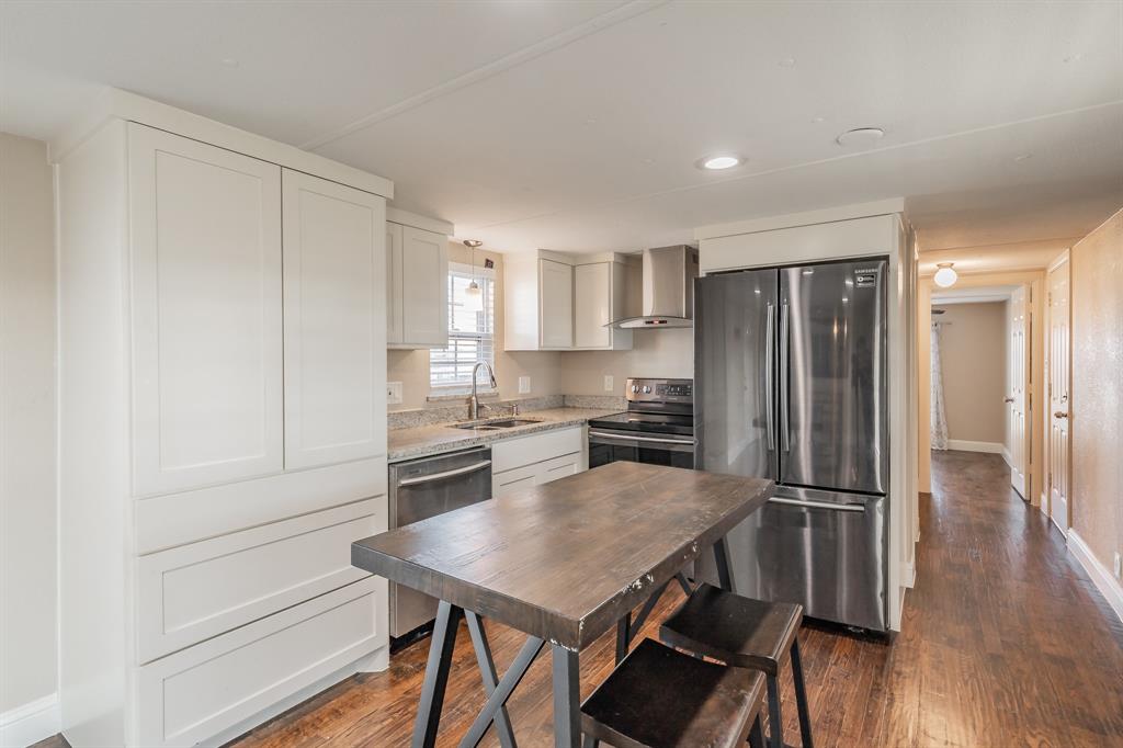1080 Crow Lane Terrell, TX 75161 - Photo 9 of 39 Kitchen featuring appliances with stainless steel finishes, range hood, white cabinetry, dark wood finished floors, and recessed lighting