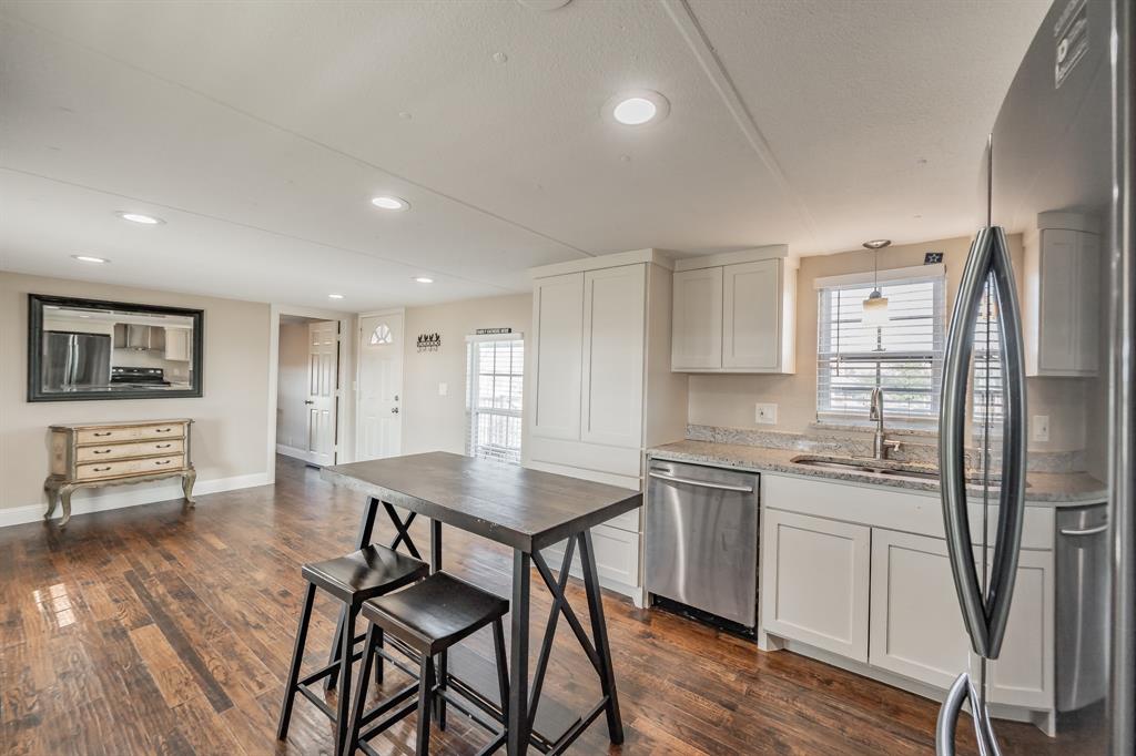 1080 Crow Lane Terrell, TX 75161 - Photo 10 of 39 Kitchen featuring appliances with stainless steel finishes, light stone countertops, white cabinetry, plenty of natural light, and recessed lighting