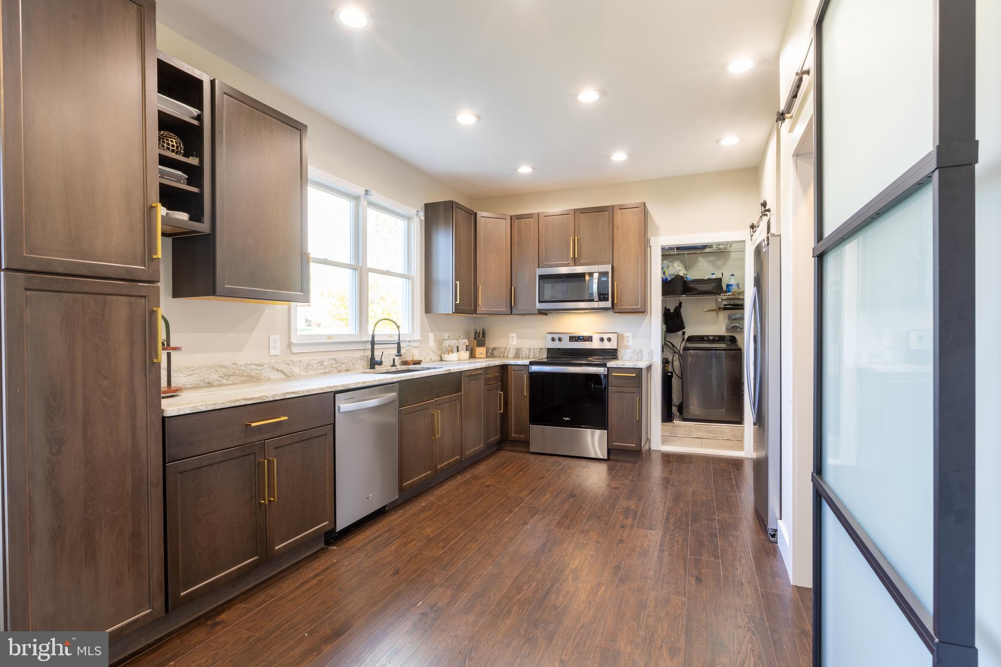 4210 Graceton Road Pylesville, MD 21132 - Photo 11 of 64 a kitchen with kitchen island granite countertop wooden floors stainless steel appliances a sink and a window