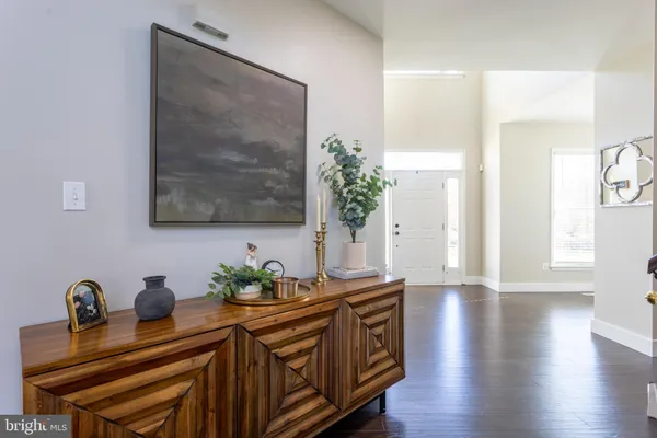 a dining room with wooden floor and potted plant