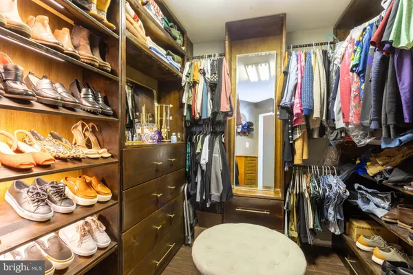 a bathroom with a shower and a tiled wall