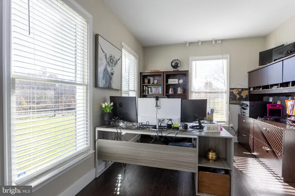 a kitchen with kitchen island granite countertop a sink stove and wooden cabinets