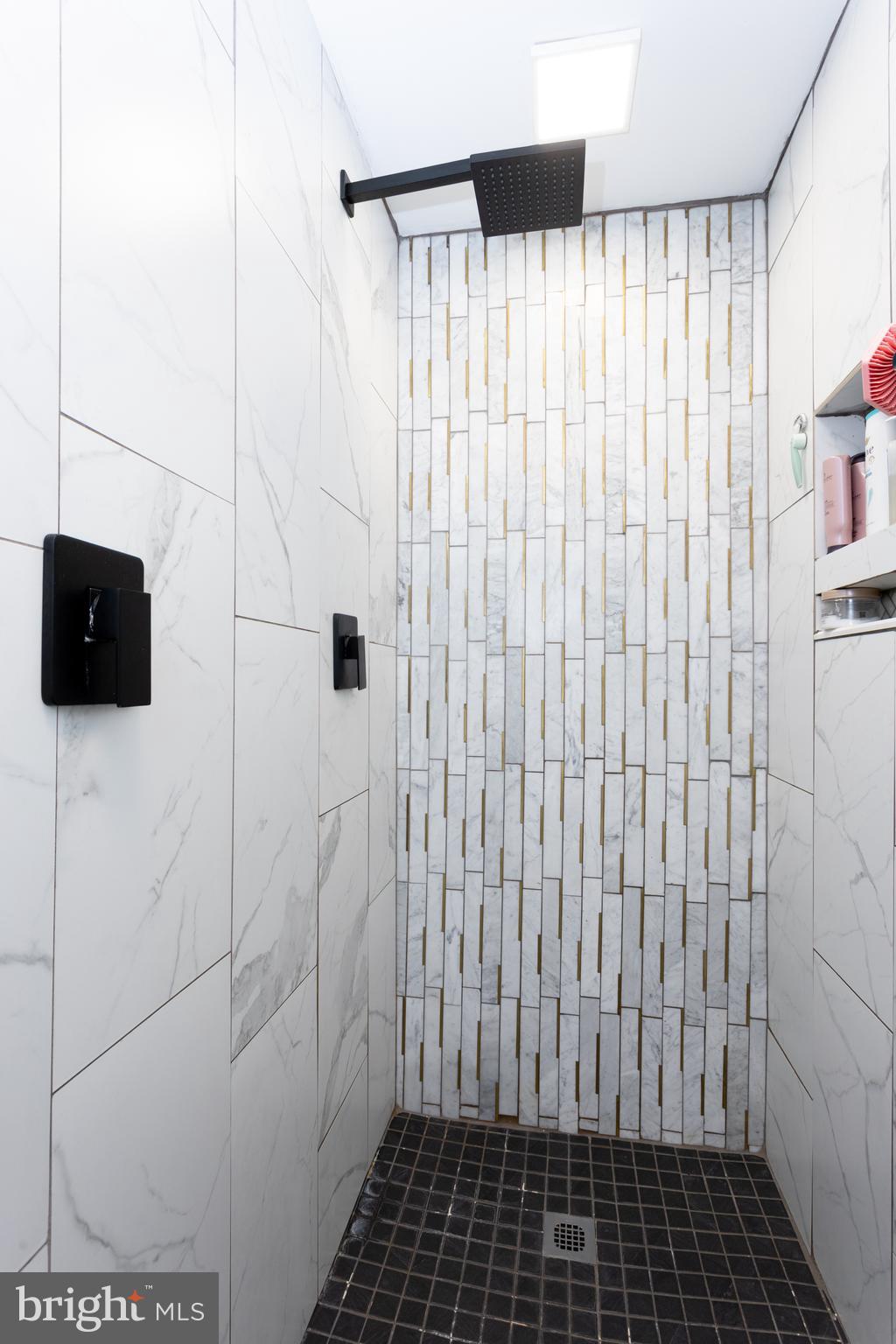 4210 Graceton Road Pylesville, MD 21132 - Photo 33 of 64 a bathroom with a shower and a tiled wall