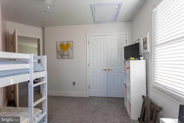 a bedroom with a bed and a table