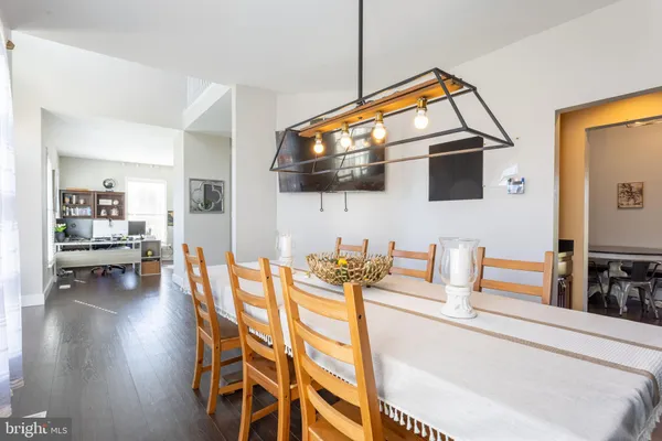 a dining room with furniture and a flat screen tv