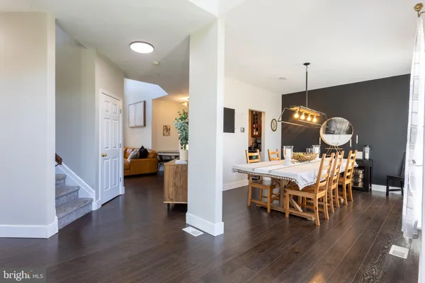 a view of living room with furniture and wooden floor