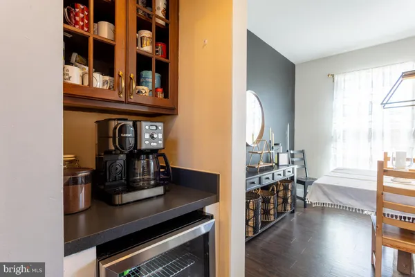 a kitchen with kitchen island granite countertop wooden floors stainless steel appliances a sink and a window