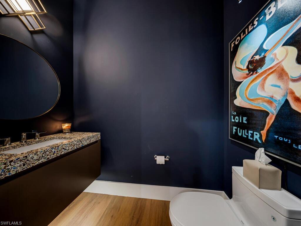 1251 Creech Road Naples, FL 34103 - Photo 11 of 44 a bathroom with a granite countertop toilet and a sink