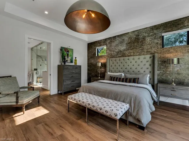 a bedroom with a bed and a chair