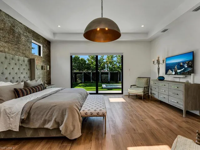 a spacious bedroom with a bed and a large window