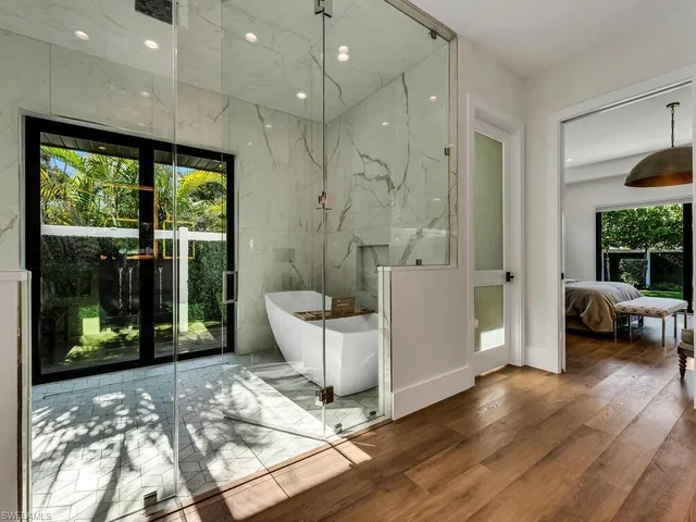 a living room with a large window and a wooden floor