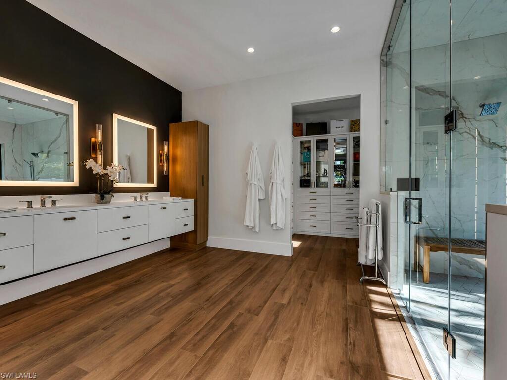 1251 Creech Road Naples, FL 34103 - Photo 17 of 44 a bathroom with a sink and mirror