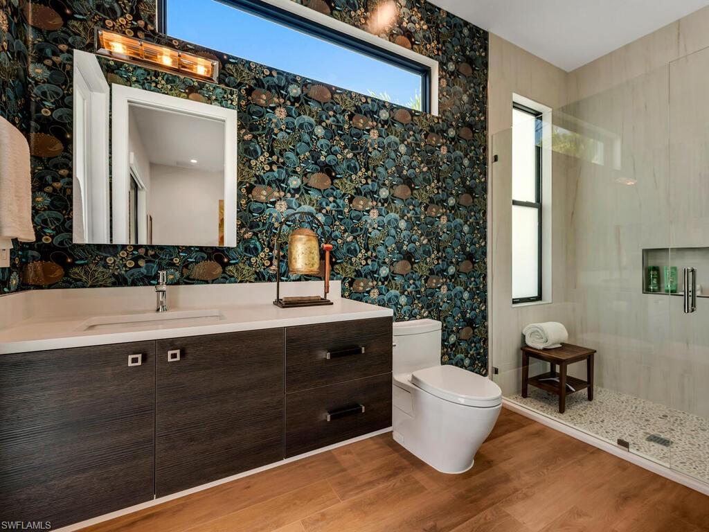 1251 Creech Road Naples, FL 34103 - Photo 22 of 44 a bathroom with a sink and a mirror