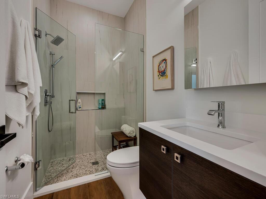 1251 Creech Road Naples, FL 34103 - Photo 23 of 44 a bathroom with a sink a toilet and shower