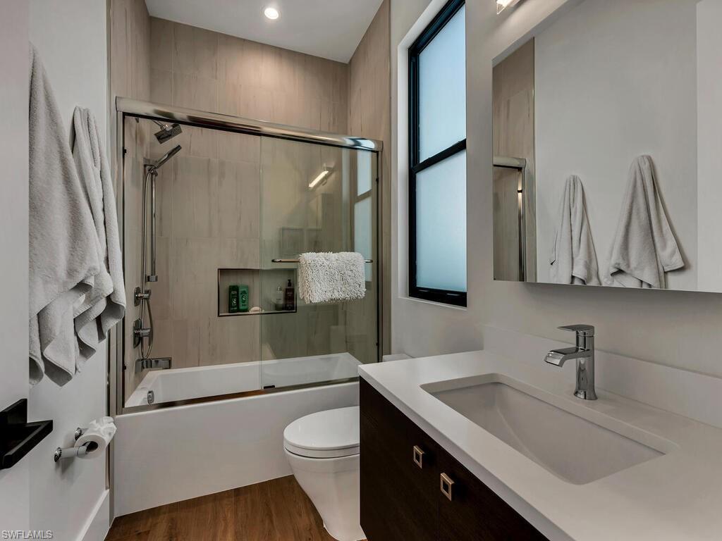 1251 Creech Road Naples, FL 34103 - Photo 25 of 44 a bathroom with a sink a toilet and a mirror