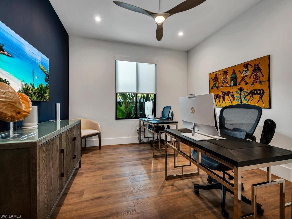 1251 Creech Road Naples, FL 34103 - Photo 27 of 42 a view of a workspace with furniture and a potted plant