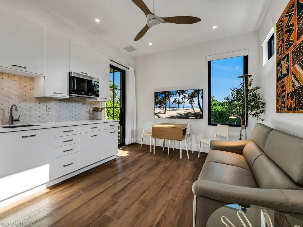 1251 Creech Road Naples, FL 34103 - Photo 28 of 44 a living room with furniture and a flat screen tv