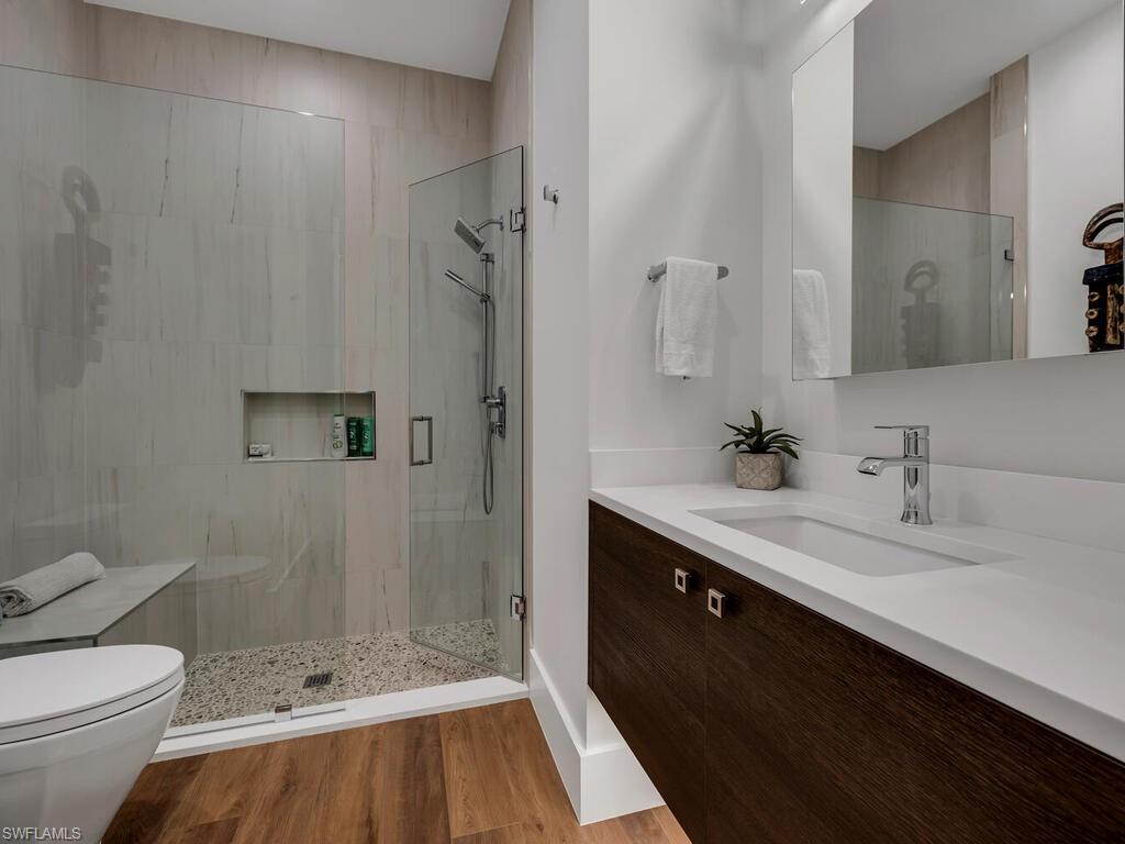1251 Creech Road Naples, FL 34103 - Photo 28 of 42 a bathroom with a sink a toilet and shower