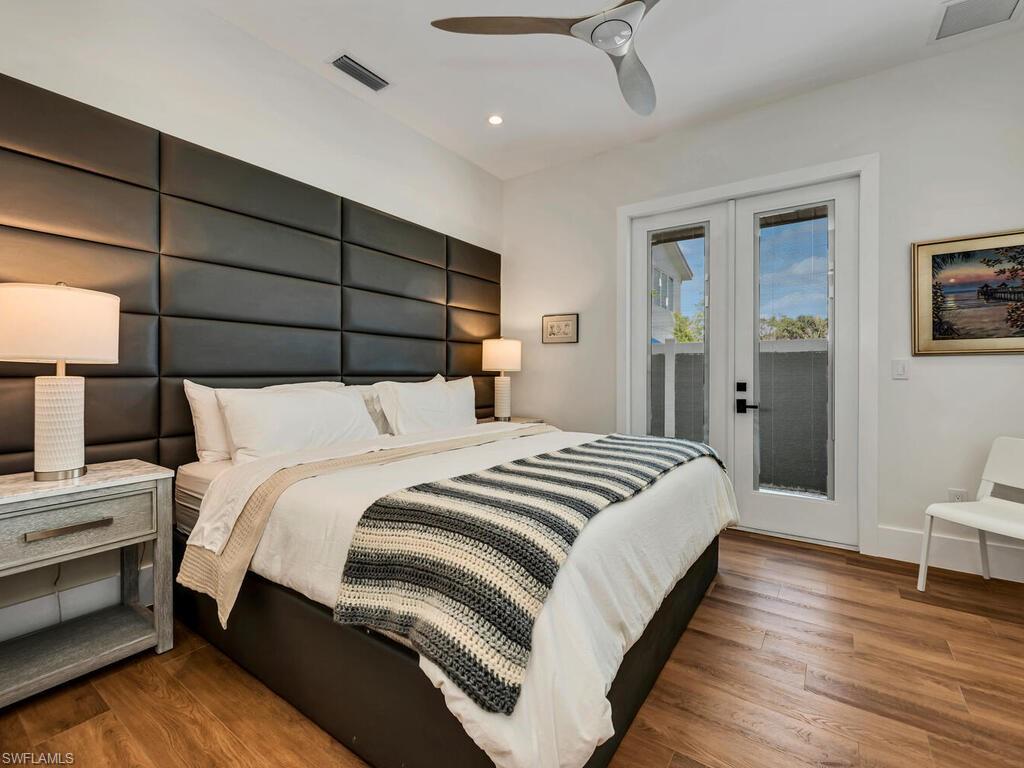 1251 Creech Road Naples, FL 34103 - Photo 30 of 42 a bedroom with a bed and a table