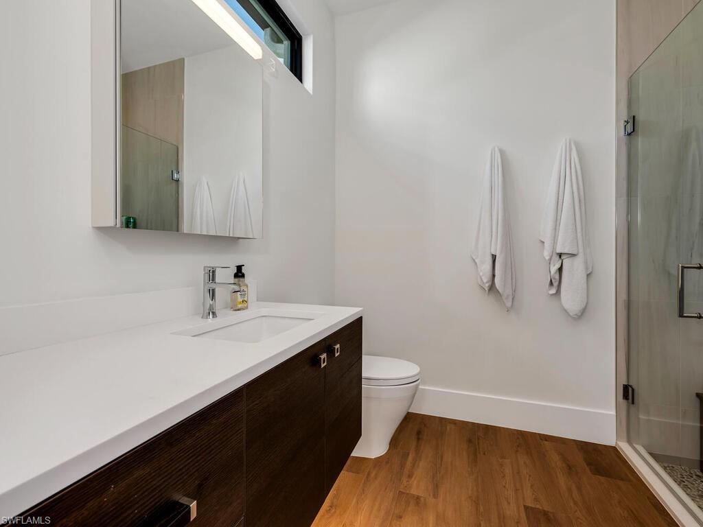 1251 Creech Road Naples, FL 34103 - Photo 31 of 42 a bathroom with a sink and a mirror