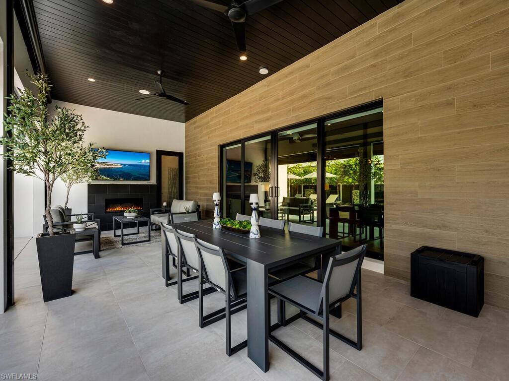1251 Creech Road Naples, FL 34103 - Photo 32 of 44 a dining room with furniture and wooden floor