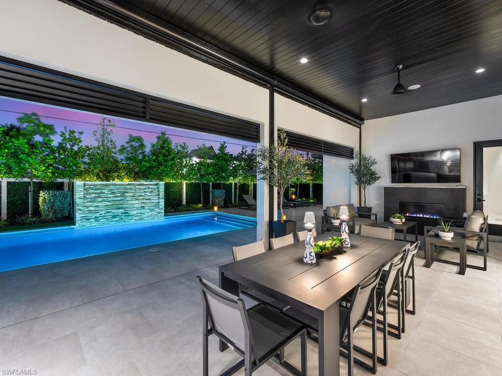 1251 Creech Road Naples, FL 34103 - Photo 36 of 44 a view of an outside dining space with furniture