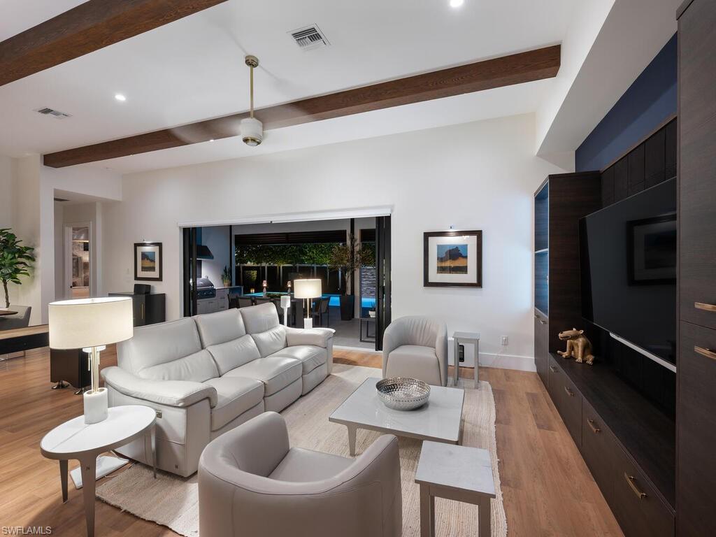 1251 Creech Road Naples, FL 34103 - Photo 42 of 44 a living room with furniture and a flat screen tv