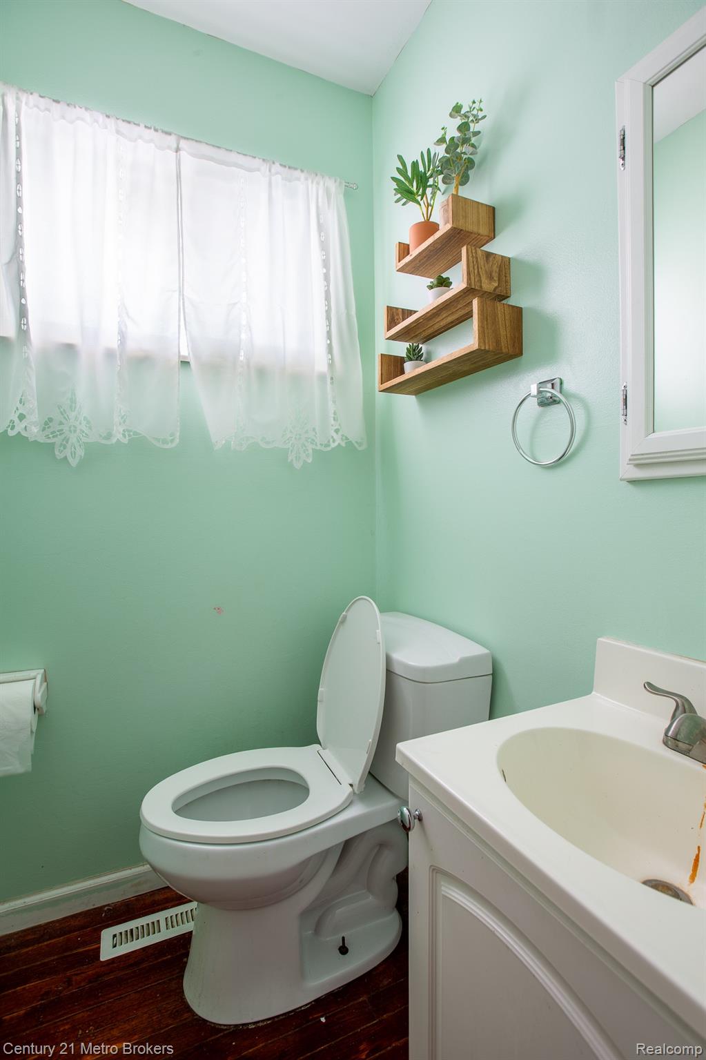 6101 Belsay Road Grand Blanc, MI 48439 - Photo 18 of 28 Bathroom with vanity and dark wood finished floors