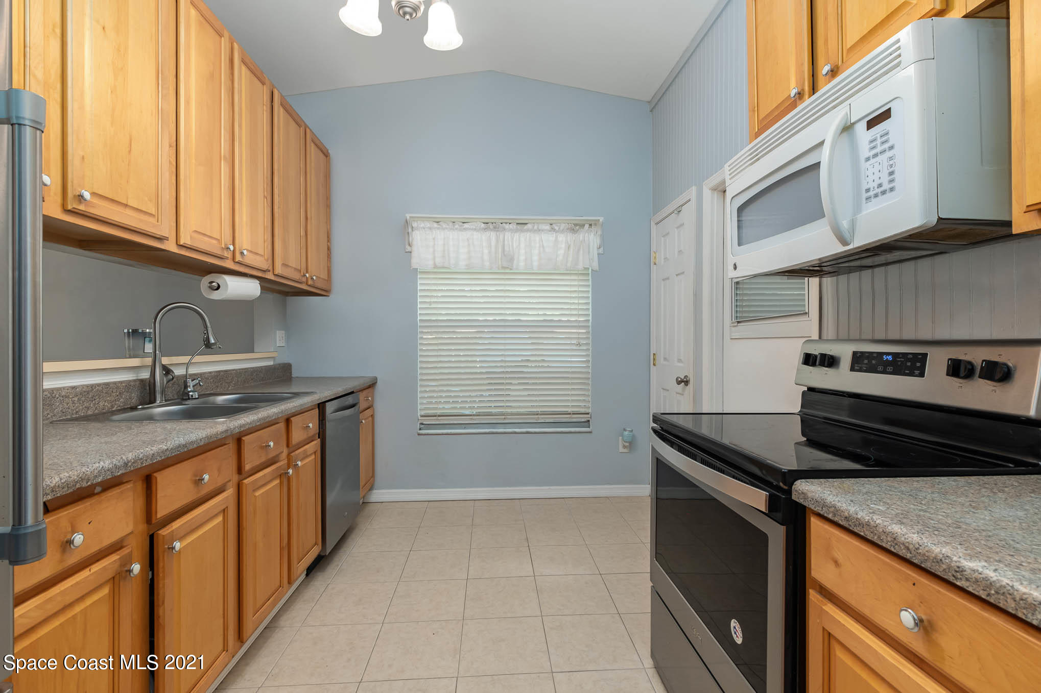3750 Ranger Street Titusville, FL 32796 - Photo 7 of 22 a kitchen with stainless steel appliances granite countertop a stove a sink and a microwave