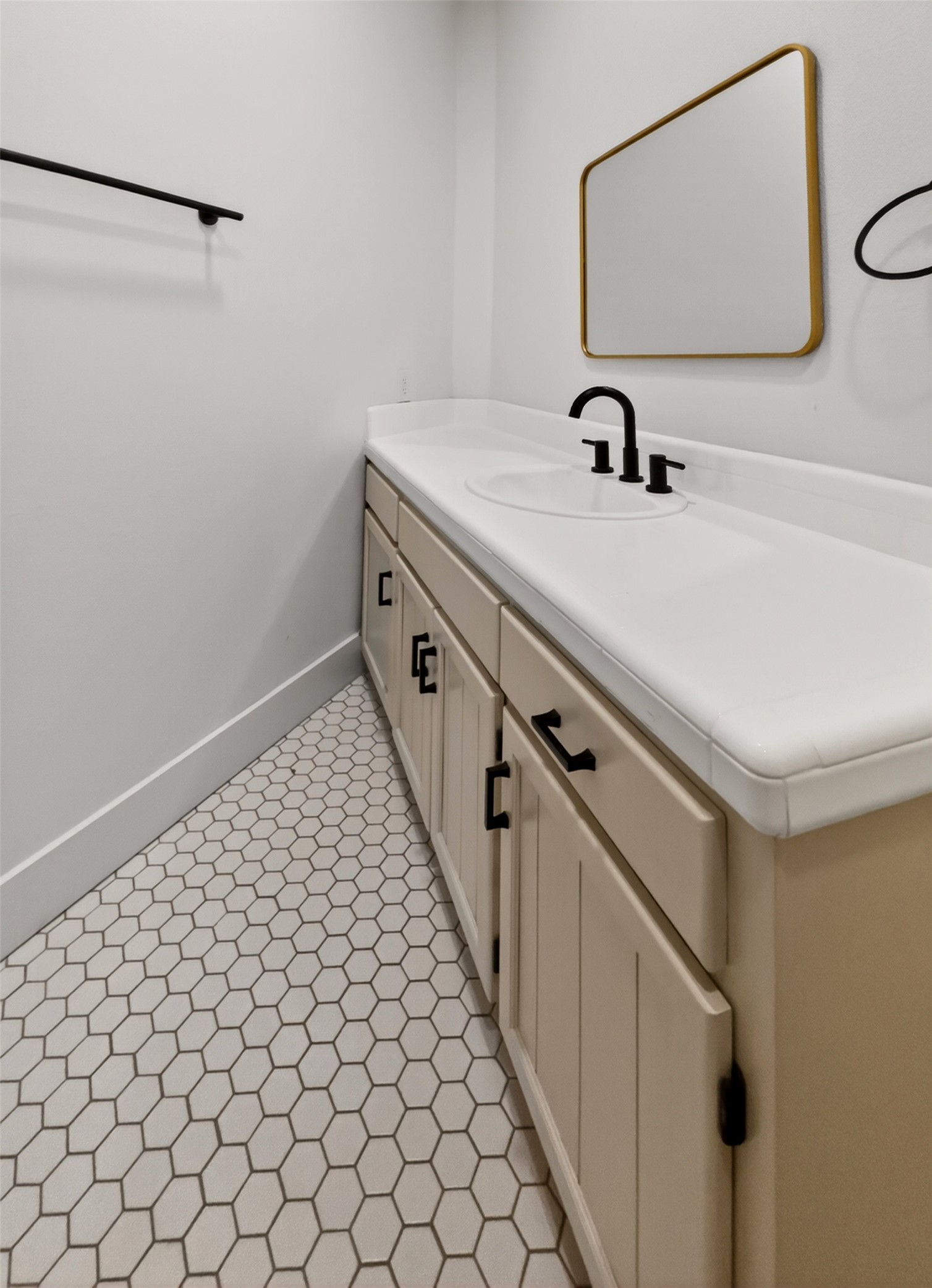 6106 Southeast Fm Ranch Buckholts, TX 76518 - Photo 19 of 38 Bathroom vanity featuring a white countertop, a black faucet, and a mirror with a gold frame