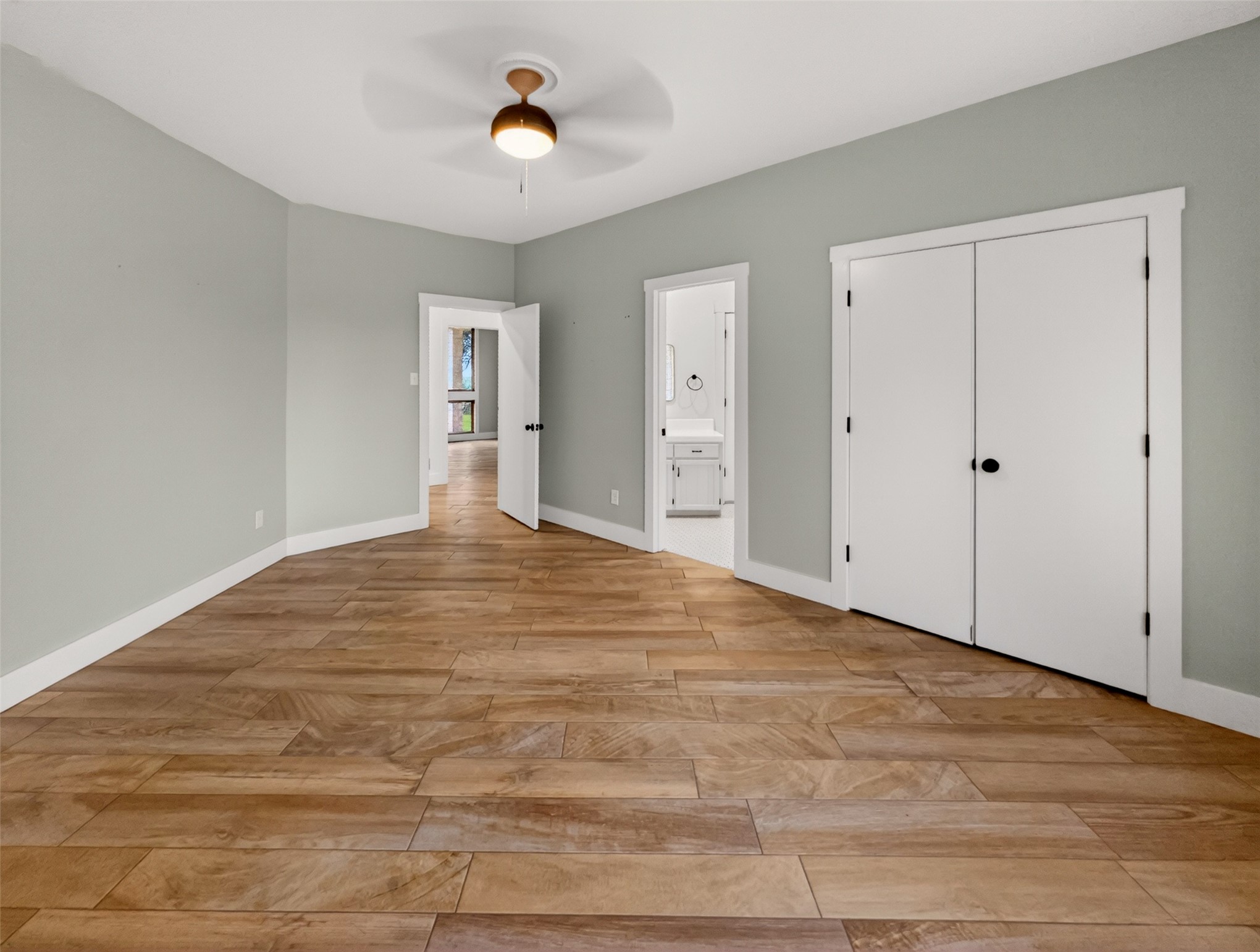 6106 Southeast Fm Ranch Buckholts, TX 76518 - Photo 20 of 38 The room features wood-look tile flooring, light-colored walls, and a ceiling fan with a light fixture