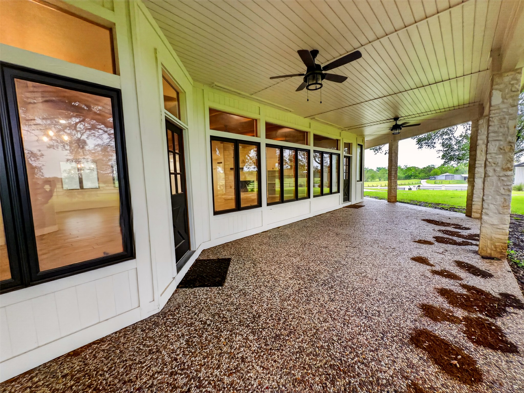 6106 Southeast Fm Ranch Buckholts, TX 76518 - Photo 27 of 38 Expansive covered porch featuring a textured concrete surface, white siding, and stone columns
