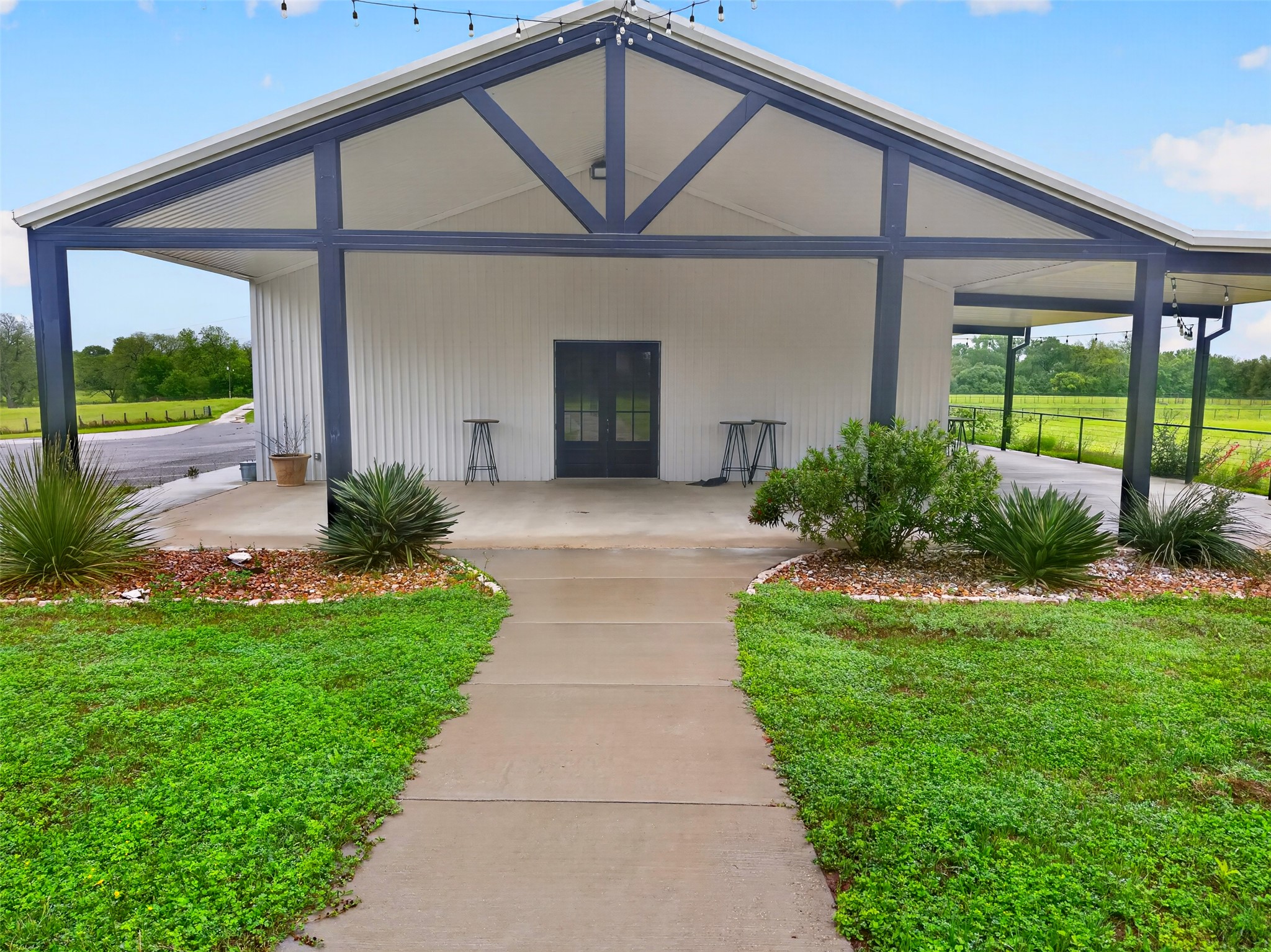 6106 Southeast Fm Ranch Buckholts, TX 76518 - Photo 28 of 38 The property features a white exterior with dark-colored structural beams and a covered porch area