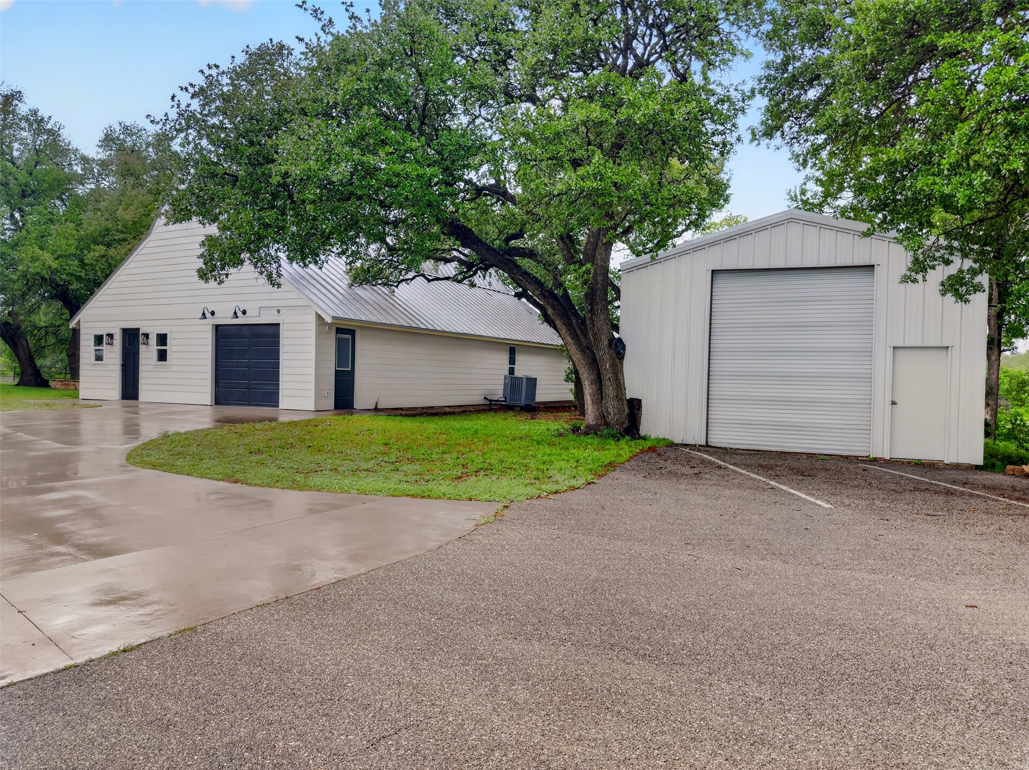 6106 Southeast Fm Ranch Buckholts, TX 76518 - Photo 38 of 38 The property features a white exterior with a metal roof and an attached garage with a dark-colored door