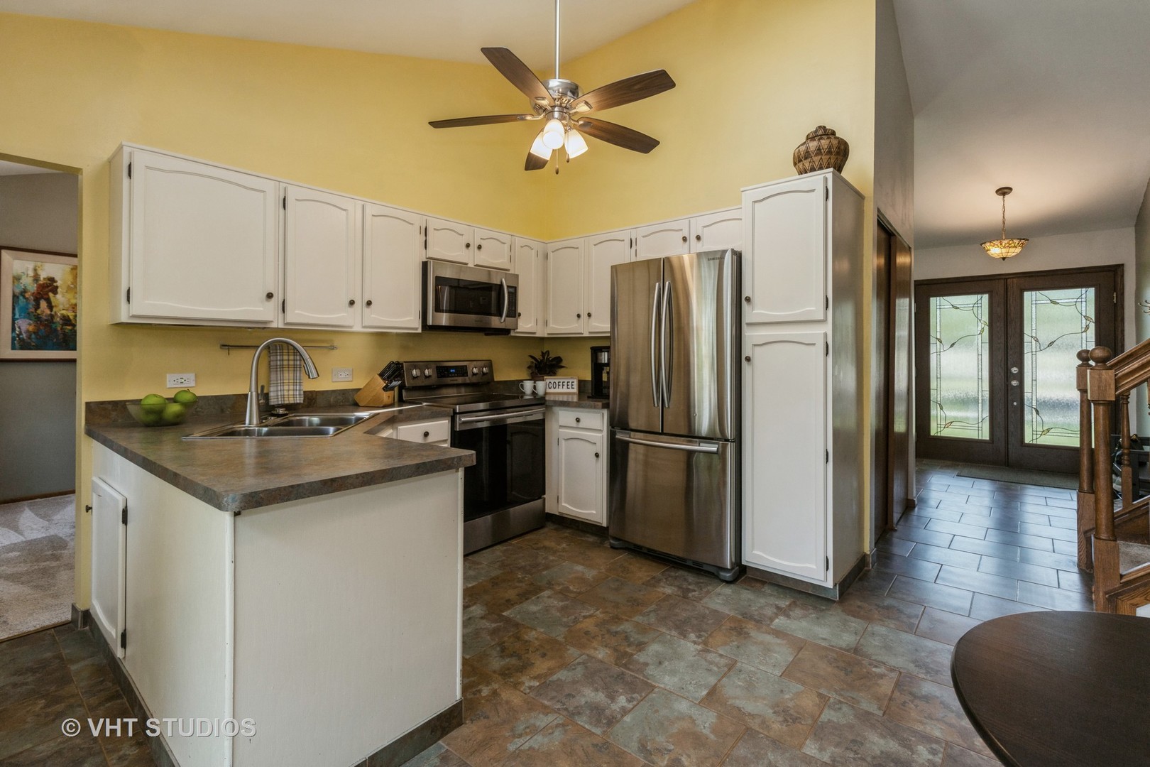 2351 Federal Circle Lindenhurst, IL 60046 - Photo 10 of 26 a kitchen with a refrigerator a stove a microwave a sink dishwasher and white cabinets with wooden floor