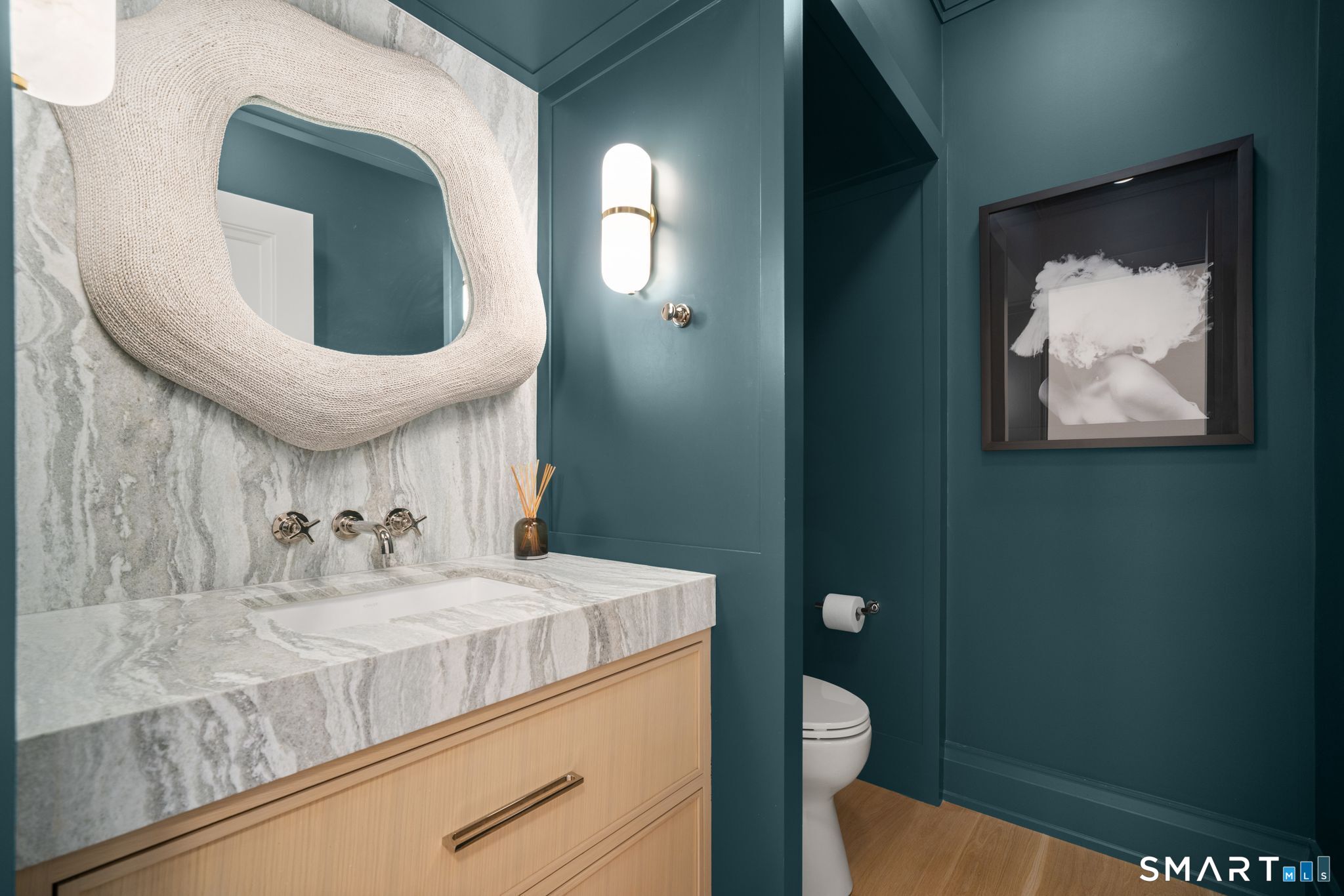69 Birch Road Fairfield, CT 06824 - Photo 15 of 40 a bathroom with a toilet sink vanity and mirror