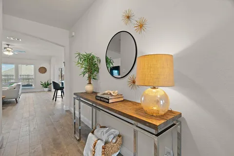 a living room with furniture and a mirror
