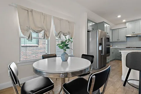 a dining room with furniture and window